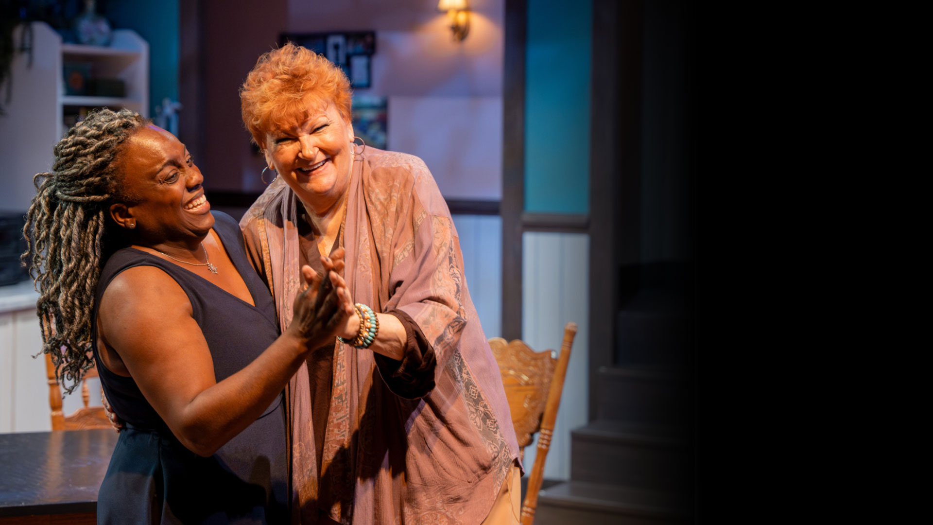 Two roommates dancing in the kitchen